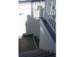 Stair enclosure on sun deck leading up down to the upper deck.